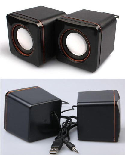 A pair of black mini portable USB wired desktop speakers with volume control knobs and a USB cable.