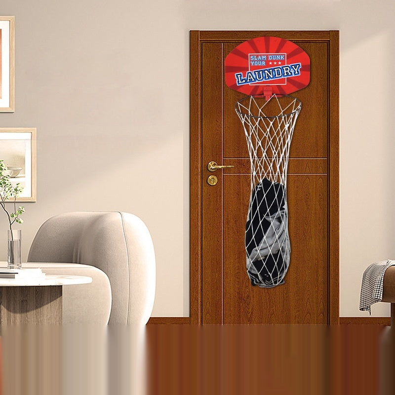 A wall-mounted plastic basketball board with a red backboard and white net, attached to a brown door in a room with a gray sofa and a white chair.