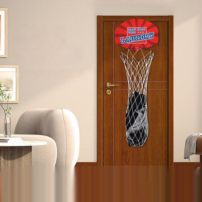 A wall-mounted plastic basketball board with a red backboard and white net, attached to a brown door in a room with a gray sofa and a white chair.