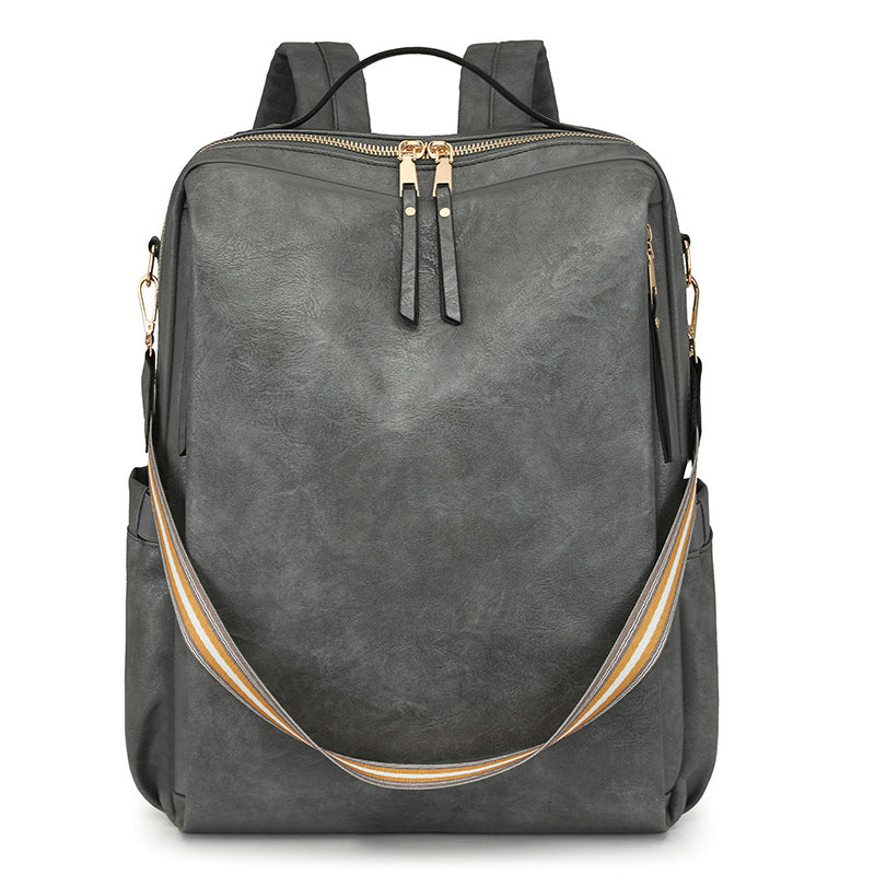 Gray backpack with gold accents on a white background