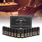 A set of essential oil bottles displayed in front of a box labeled 'Top 14 Blends Aromatherapy Essential Oil Set', with a person receiving a massage in the background.