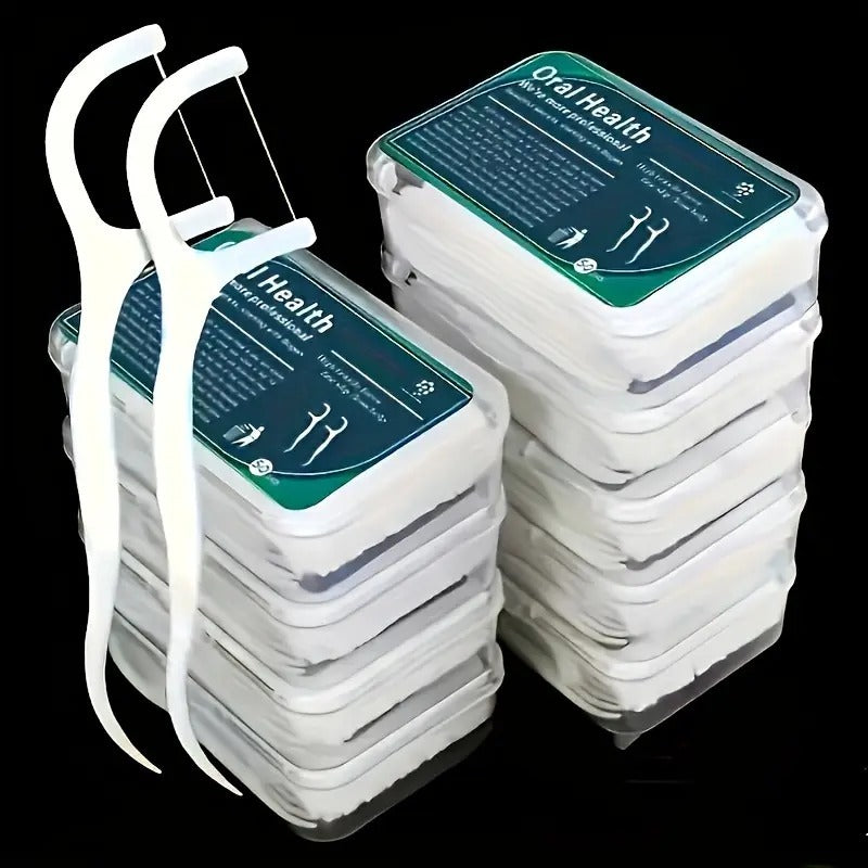 Stacks of dental floss containers with a stethoscope on a black background