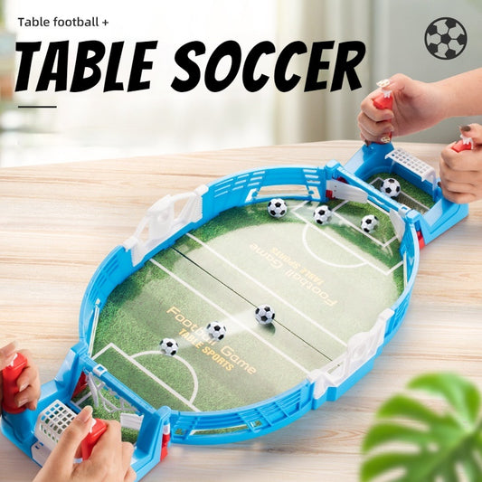 Mini football table game being played by two individuals, featuring a portable tabletop with balls and goals.