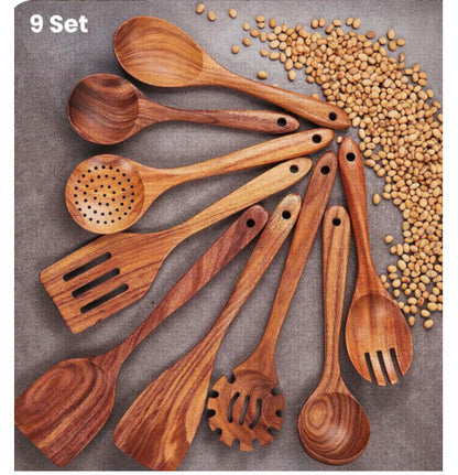 Set of wooden kitchen utensils on a surface with dried beans.