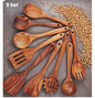 Set of wooden kitchen utensils on a surface with dried beans.