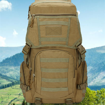 A multifunctional hiking bag in khaki color with camouflage pattern, featuring multiple compartments and external pouches, positioned against a scenic landscape.