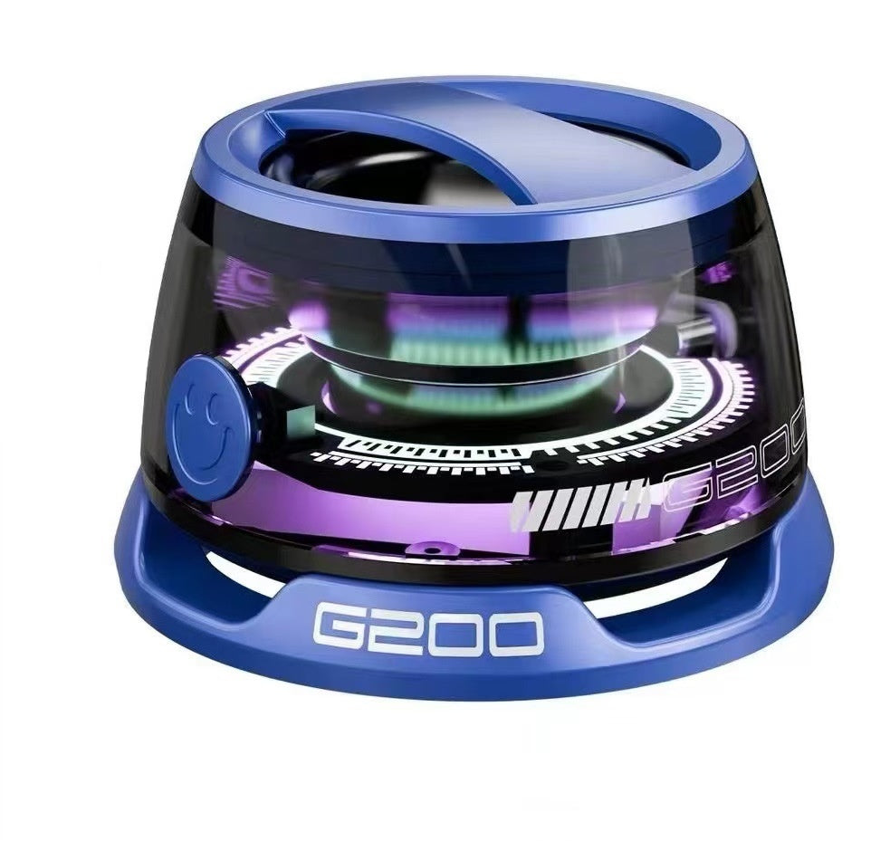A portable Bluetooth speaker with RGB lighting, displayed in a transparent case, showing internal components and a magnetic phone holder.
