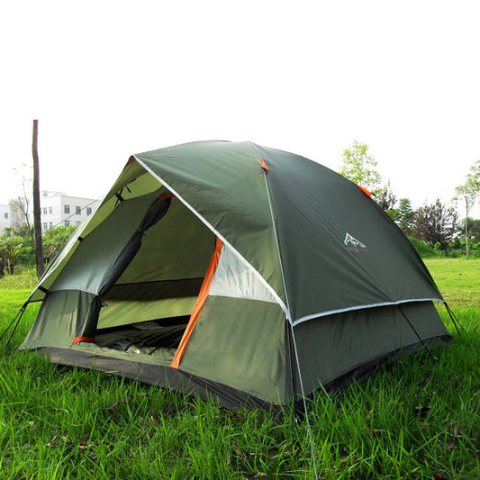 A green and gray camping tent pitched on grassy terrain with a visible orange entrance.