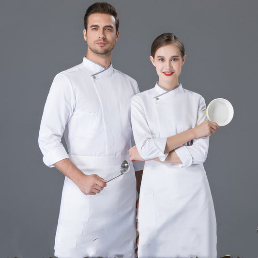 A male and a female chef in white uniform, the male chef holding a metal tray and the female chef holding a white plate.