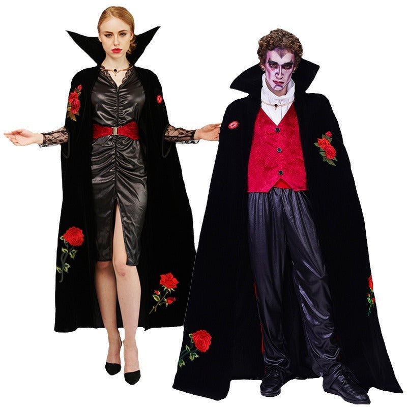 A couple wearing Halloween costumes, with rose embroidery details, one as a female character in black with red roses and the other as a male character in a red vest with black cape.