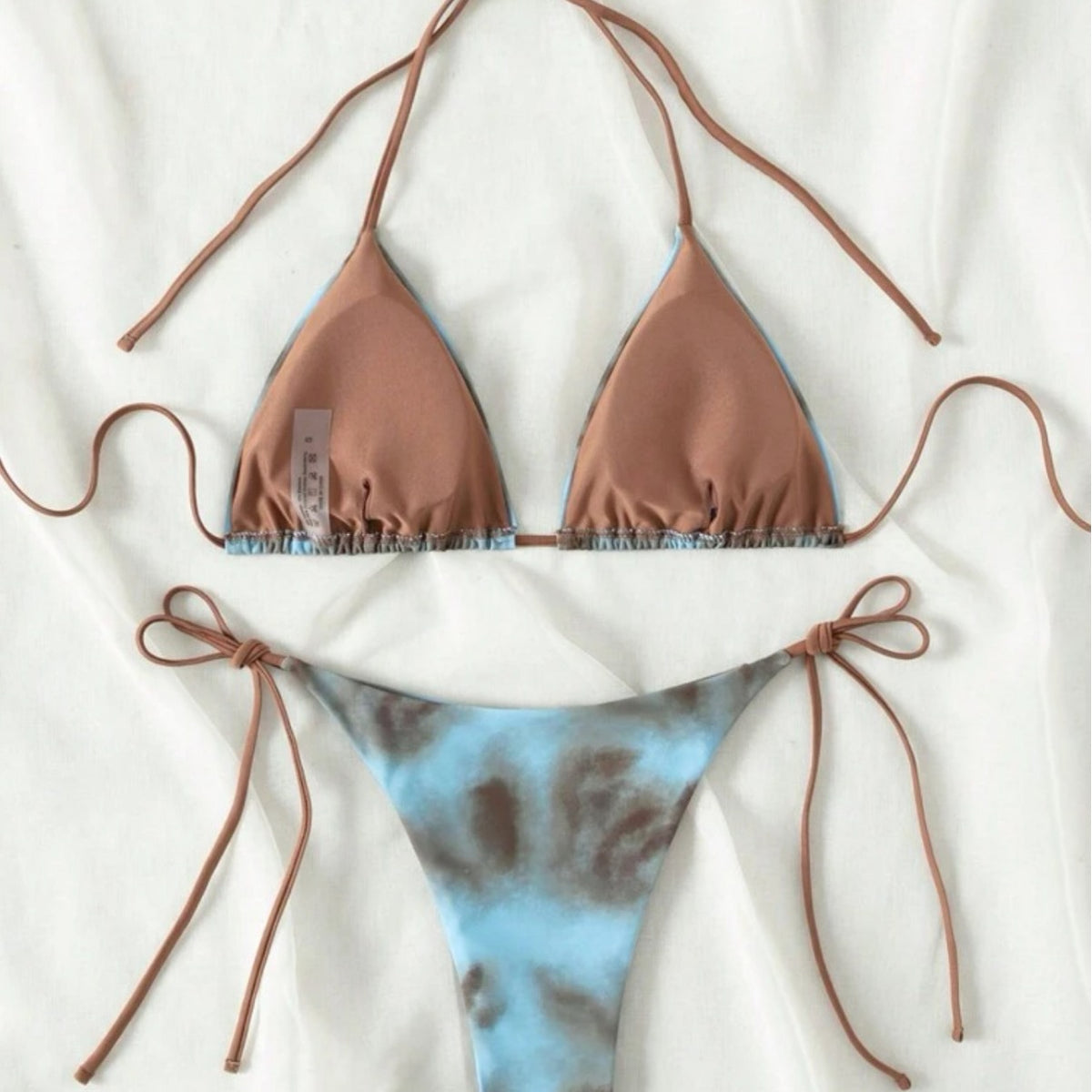 Tie-dye bikini set with brown and blue pattern on a white background