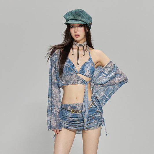 A woman wearing a blue plaid split bikini top with a cover-up, shorts, and a green beret.
