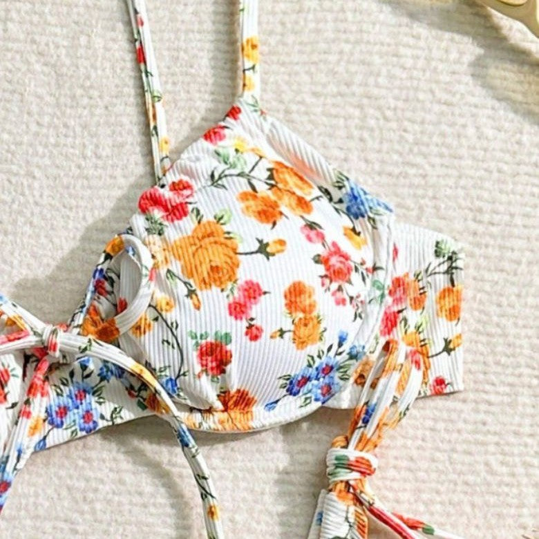 Floral-patterned bikini top on a textured surface