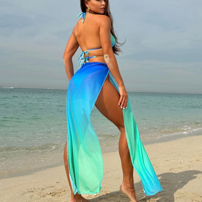 Woman in blue and green swimsuit on a beach
