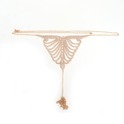 Gold skeleton-themed necklace on a white background