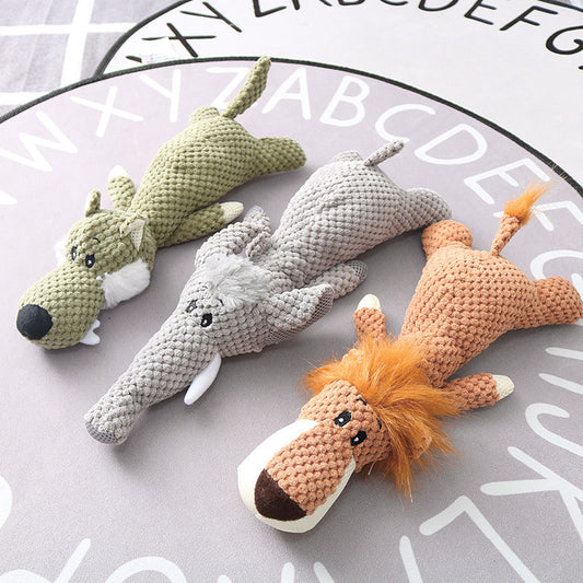 A set of plush dog toys in the shapes of a crocodile, a bear, a wolf, and a lion, laid out on a grey background with alphabet letters.