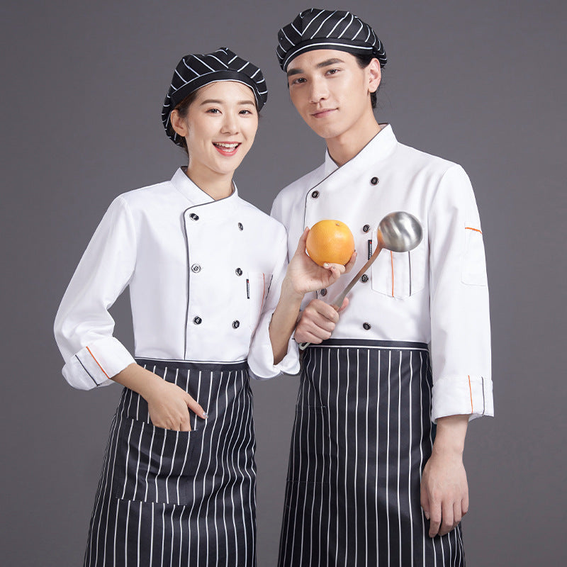 Two chefs wearing white work clothes with grey stripes, one holding a orange and the other holding a metal scoop.