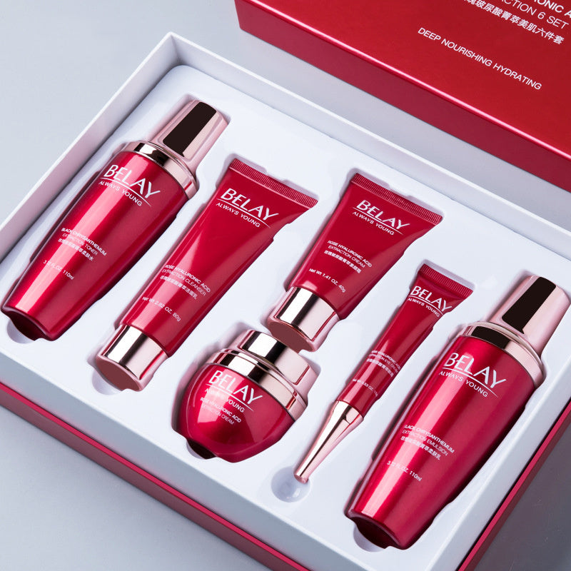 Cosmetic set with red and pink bottles and tubes in a box.