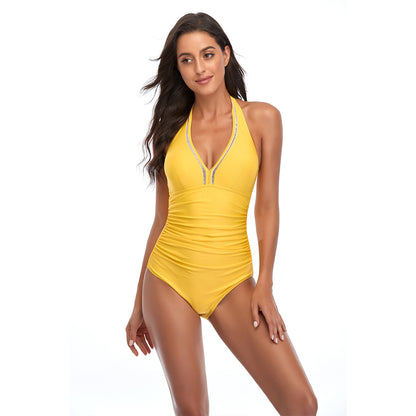 A woman wearing a red halterneck one-piece swimsuit with lace-up details at the front.