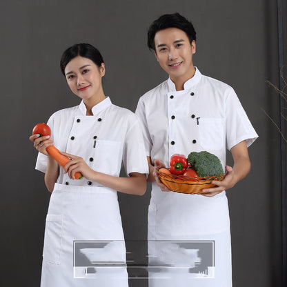 Two chefs, one male and one female, wearing white short-sleeved chef uniforms, holding a basket of vegetables and a carrot respectively, against a grey background.