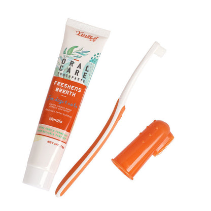 Toothpaste tube and brush with orange handle on white background