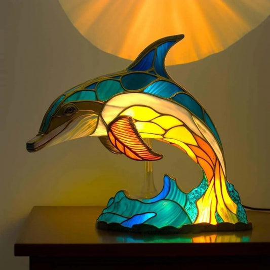 A collection of colored glass animal-shaped desk lamps, including representations of an owl, elephant, unicorn, and others, with a multicolored pattern.