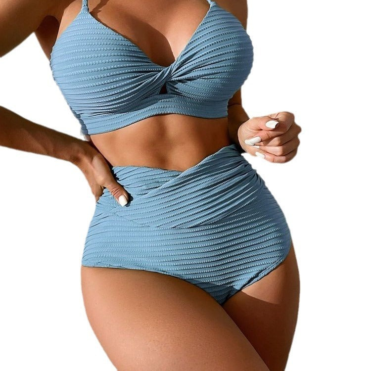 Blue textured bikini set worn by a person on a white background.