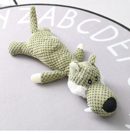 Crocheted dog toy on a gray surface with alphabet letters.