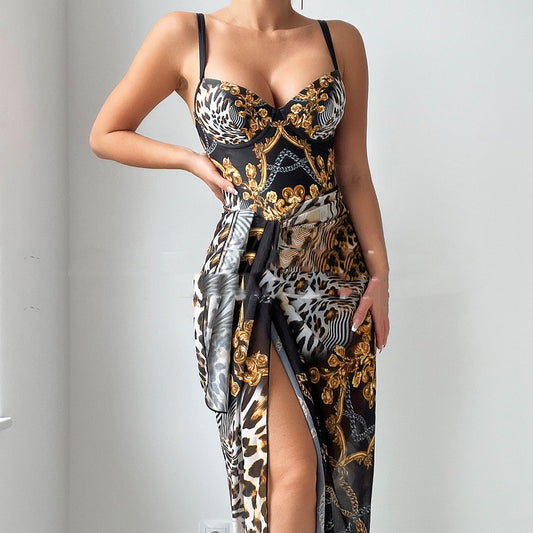 A woman wearing a black one-piece swimsuit with a geometric and animal print design, featuring a double shoulder with steel bracket gathering.
