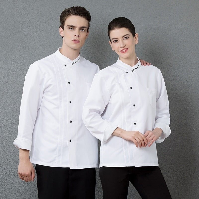 A male and a female chef wearing white chef overalls with black buttons, standing against a grey background.