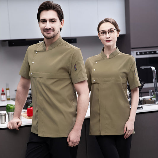 A male and a female chef wearing professional chef uniforms in a kitchen setting. The uniforms are short-sleeved, button-up shirts in a beige color.