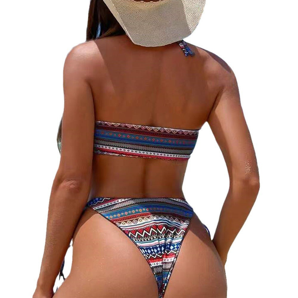 Person wearing a colorful patterned bikini swimsuit.