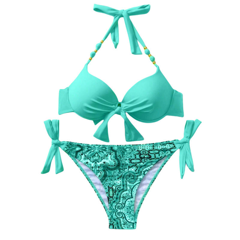 Turquoise bikini set with decorative pattern on bottom on a white background