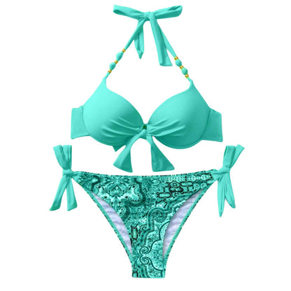 Turquoise bikini set with decorative pattern on bottom on a white background
