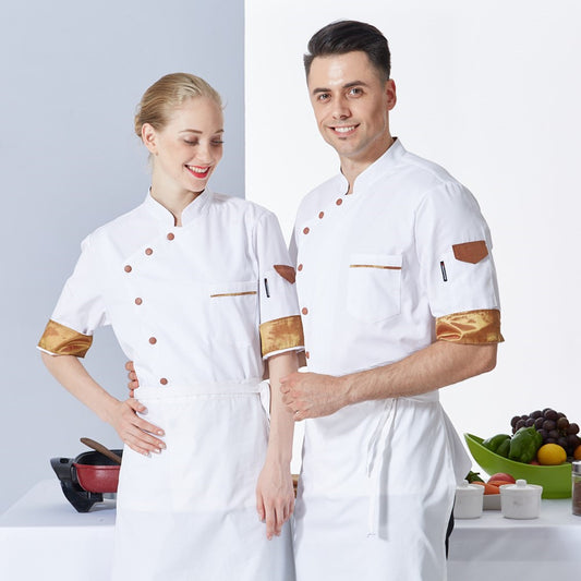 Two chefs wearing white uniforms with long sleeves and different colored edges, standing in a kitchen setting.