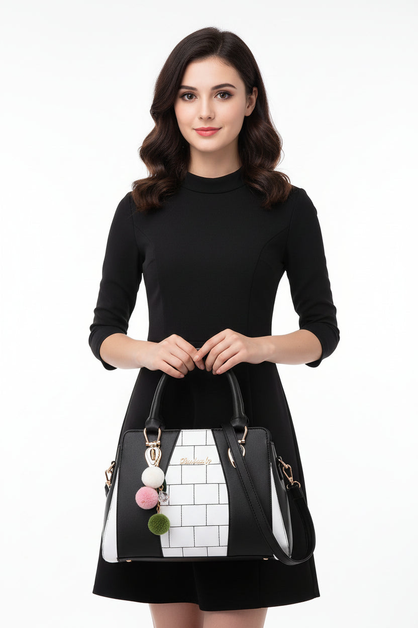 A shoulder bag with black and white geometric design, featuring a pink and green chain detail, and a polyester cotton lining.