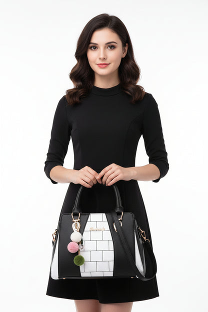 A shoulder bag with black and white geometric design, featuring a pink and green chain detail, and a polyester cotton lining.