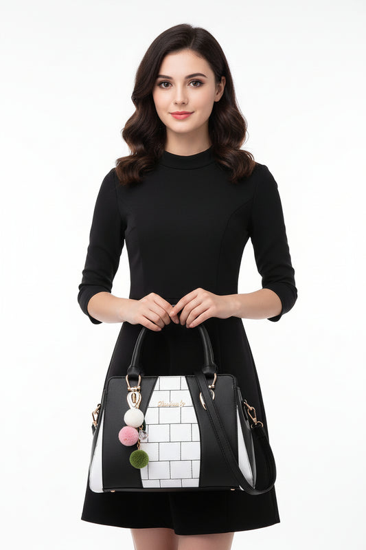 A shoulder bag with black and white geometric design, featuring a pink and green chain detail, and a polyester cotton lining.